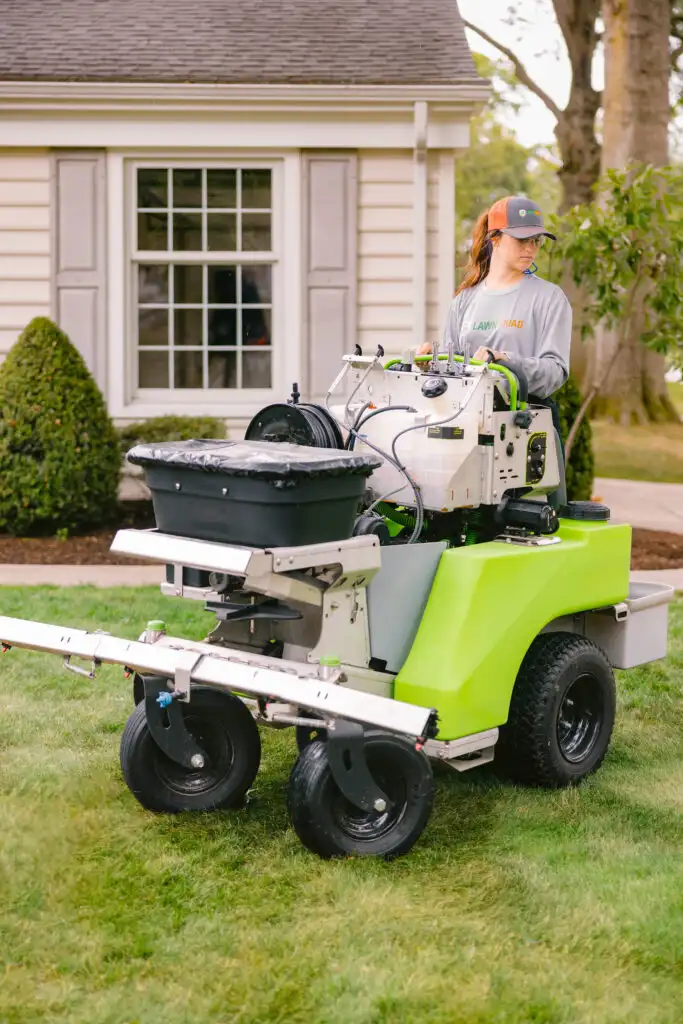 Lawn Squad technician inspecting turf health